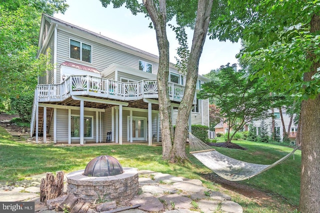 11905 Champion Lake Ct, Herndon, VA 20170 - rear view of house with an outdoor fire pit, a deck, a lawn, and stairs