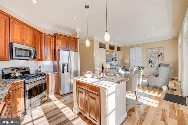 kitchen featuring light stone counters, a center island, backsplash, and stainless steel appliances