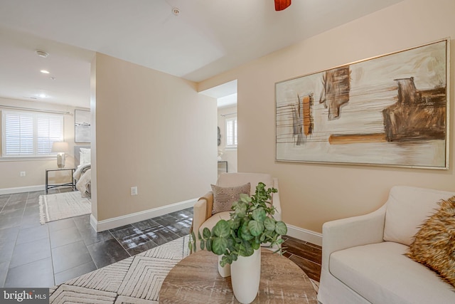 living room with tile patterned floors and baseboards