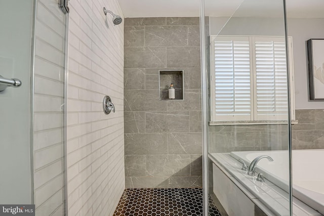 bathroom featuring a garden tub and a stall shower