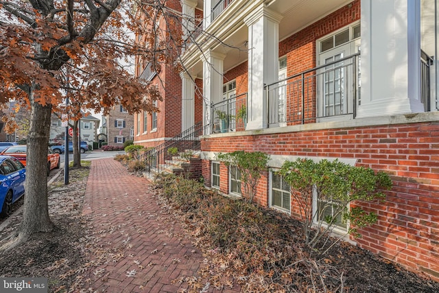 view of property exterior featuring brick siding and a residential view