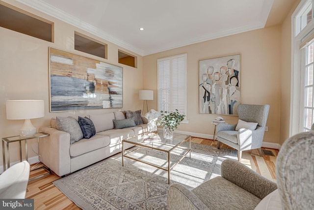 living room with recessed lighting, wood finished floors, baseboards, and ornamental molding