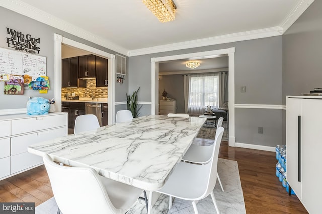 dining room with crown molding, baseboards, and dark wood-style flooring