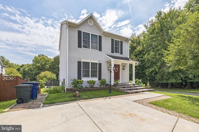 view of front facade with a front yard and fence