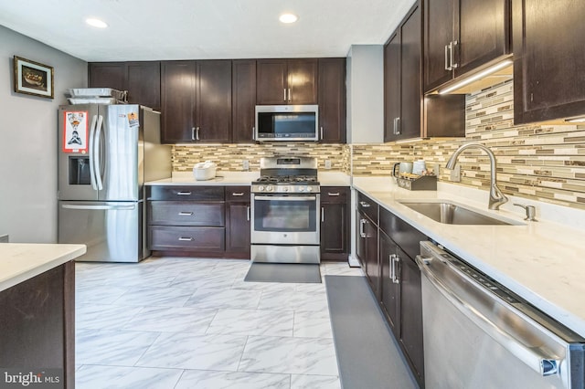 kitchen featuring a sink, stainless steel appliances, dark brown cabinets, marble finish floor, and tasteful backsplash