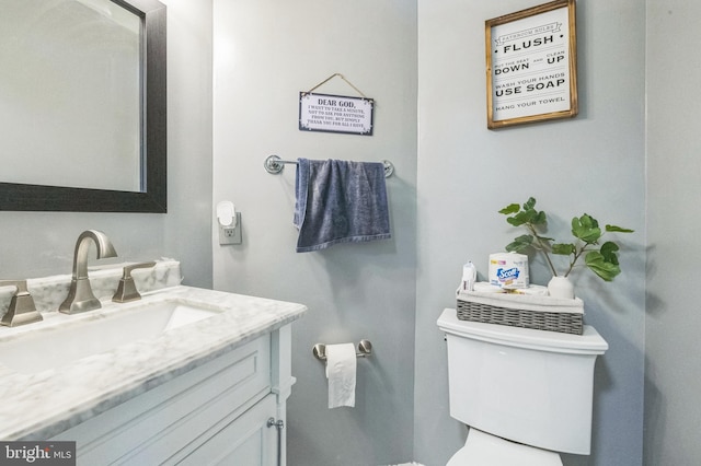 half bathroom with toilet and vanity