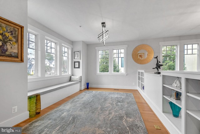 dining space with wood finished floors and baseboards