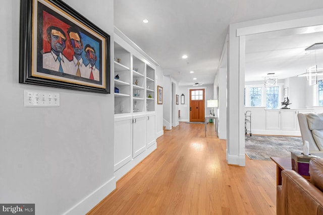 hall featuring recessed lighting, light wood-style floors, and baseboards