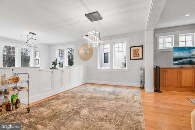 dining room with light wood-style flooring and baseboards