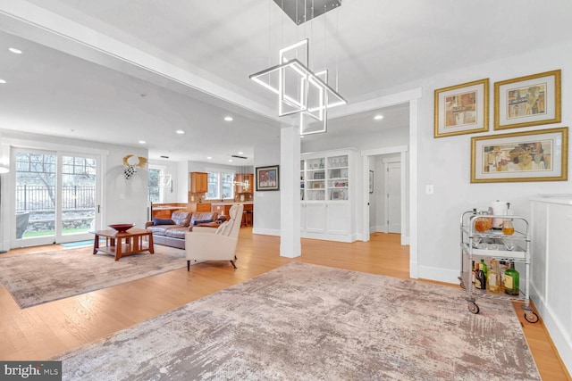 living area featuring recessed lighting, plenty of natural light, and wood finished floors