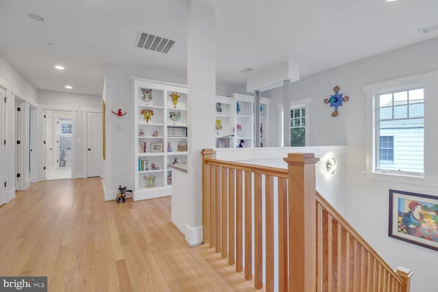 hallway featuring light wood-style flooring, recessed lighting, an upstairs landing, and visible vents