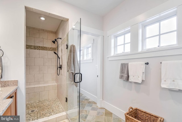 bathroom featuring recessed lighting, a shower stall, vanity, and baseboards