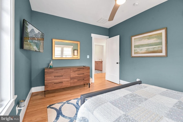 bedroom featuring light wood-type flooring, visible vents, baseboards, and ceiling fan