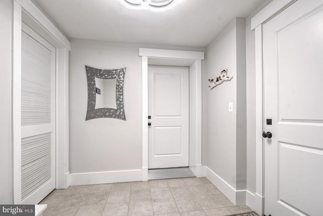 interior space with light tile patterned floors and baseboards