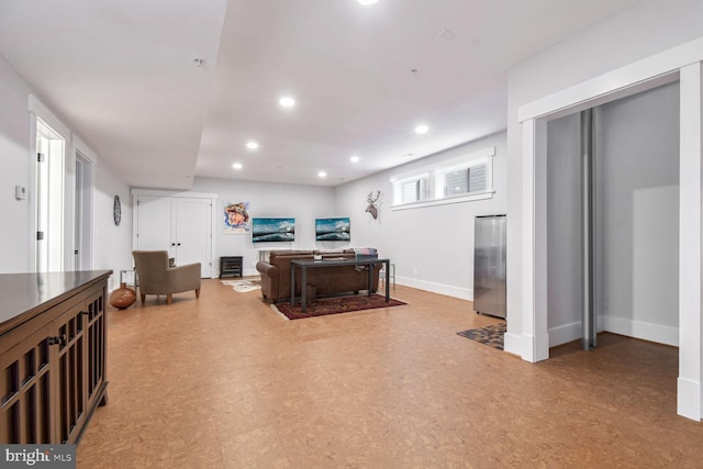 interior space with recessed lighting, light floors, and baseboards