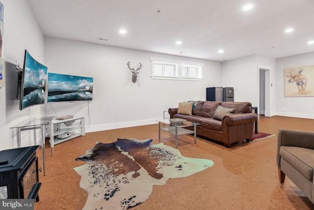 living area featuring recessed lighting and baseboards