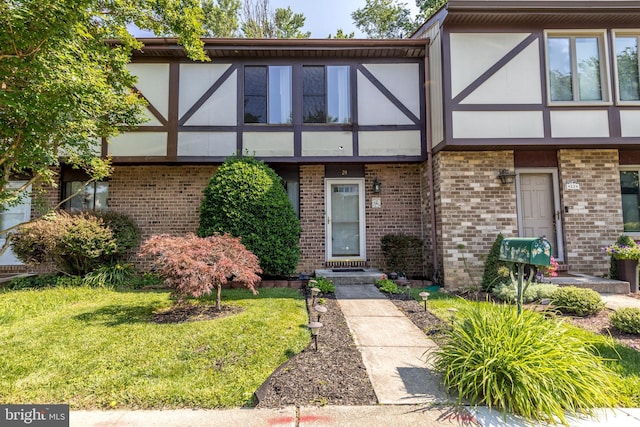 24 W Orange Ct, Baltimore, MD 21234 - tudor-style house featuring brick siding, stucco siding, and a front lawn