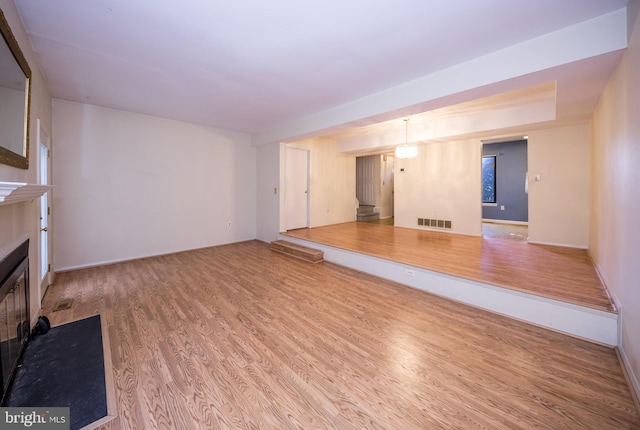 24 W Orange Ct, Baltimore, MD 21234 - unfurnished living room with wood finished floors, a fireplace with flush hearth, and baseboards