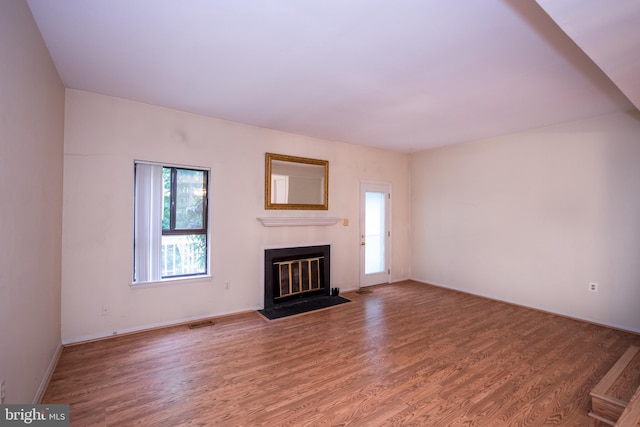 24 W Orange Ct, Baltimore, MD 21234 - unfurnished living room with wood finished floors, a fireplace with flush hearth, and baseboards