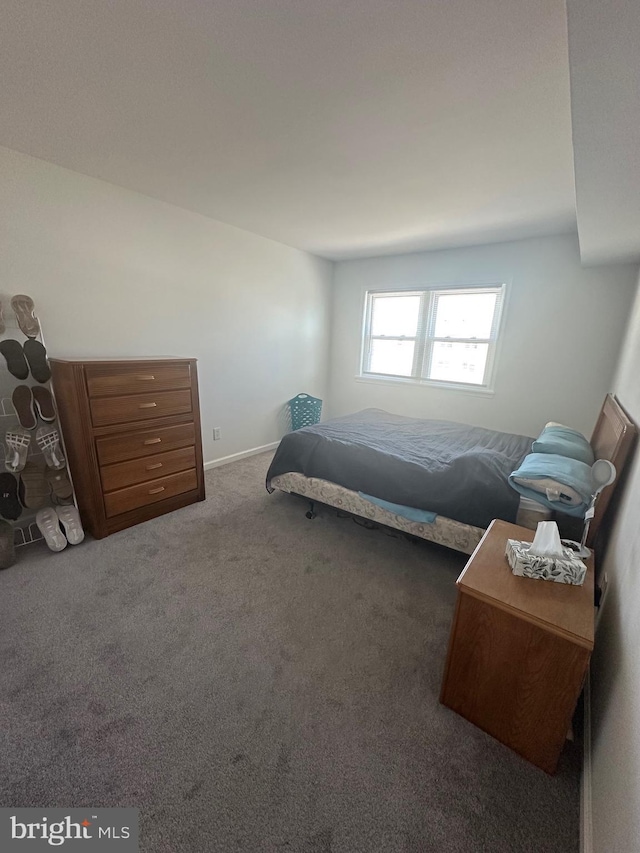 carpeted bedroom featuring baseboards