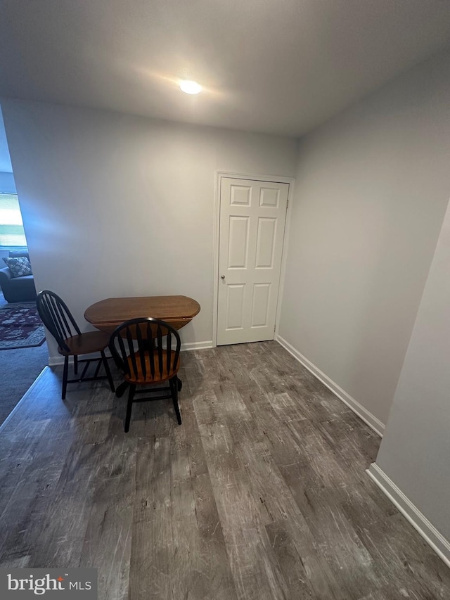 dining room with dark wood finished floors and baseboards