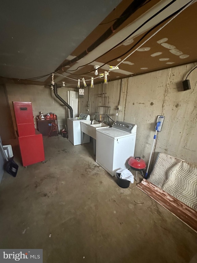 unfinished basement with a sink and washing machine and dryer