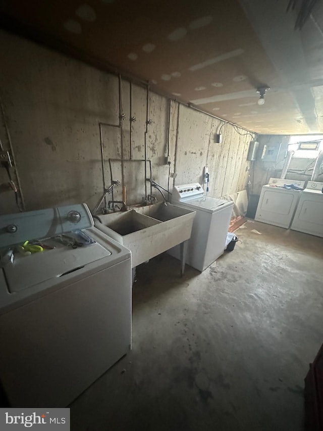 laundry room with a sink, laundry area, and washing machine and clothes dryer