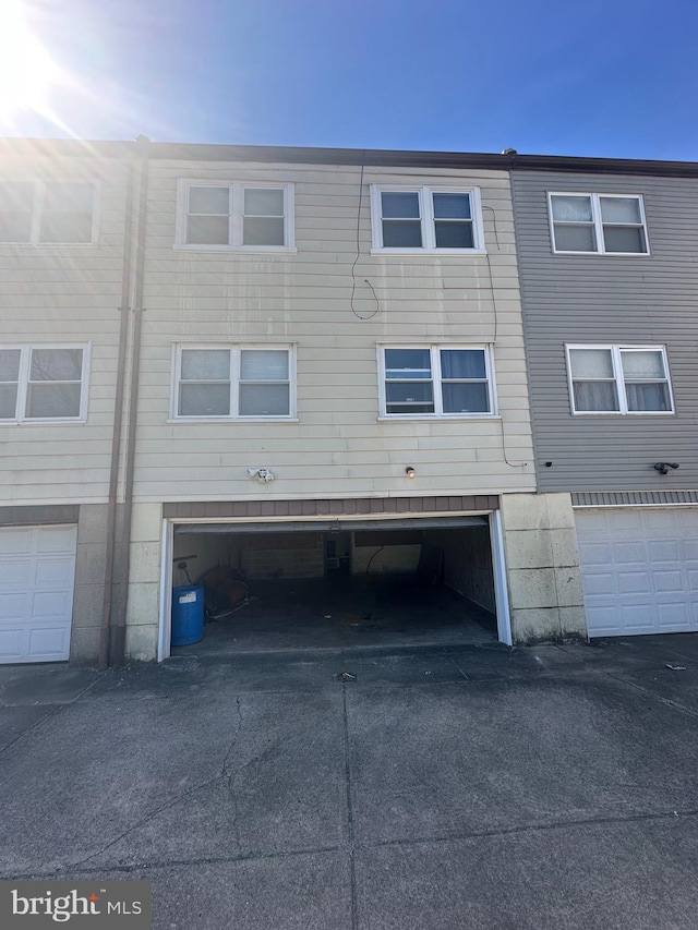 rear view of property featuring a garage