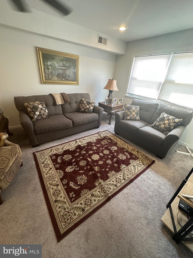 living room with visible vents and carpet