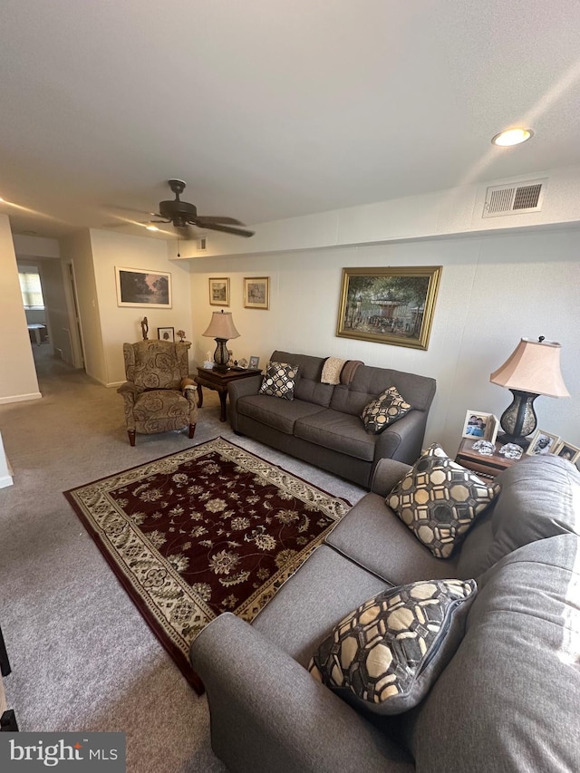 carpeted living room with visible vents and ceiling fan