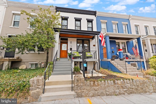 townhome / multi-family property with brick siding