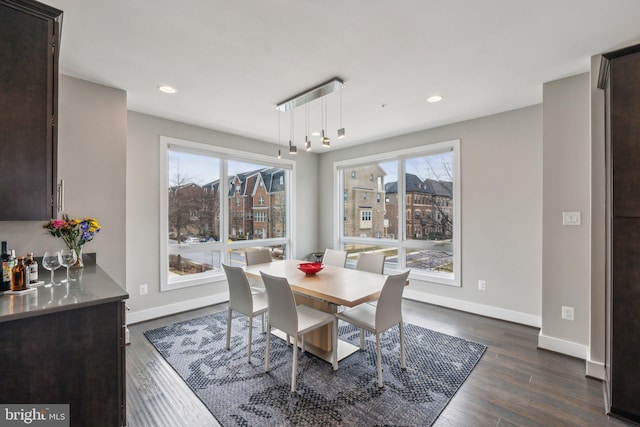 dining room featuring recessed lighting, dark wood-type flooring, and baseboards