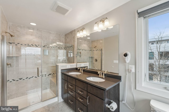 full bathroom with a sink, visible vents, and a shower stall