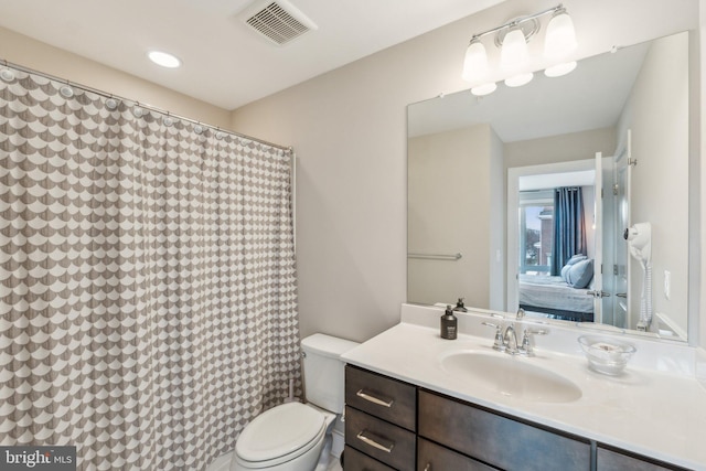 bathroom with ensuite bath, visible vents, toilet, and vanity