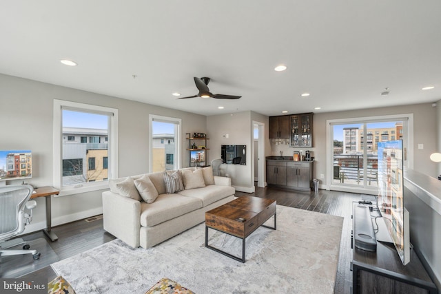 living area with recessed lighting, ceiling fan, baseboards, and dark wood-style flooring