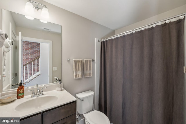 bathroom with visible vents, toilet, and vanity