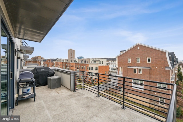 balcony featuring a city view and grilling area