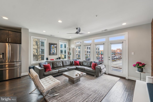 living room featuring dark wood-type flooring, recessed lighting, and a healthy amount of sunlight