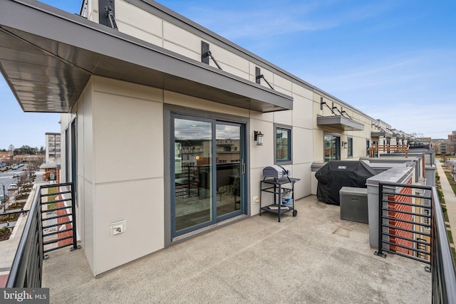 view of patio with grilling area and a balcony