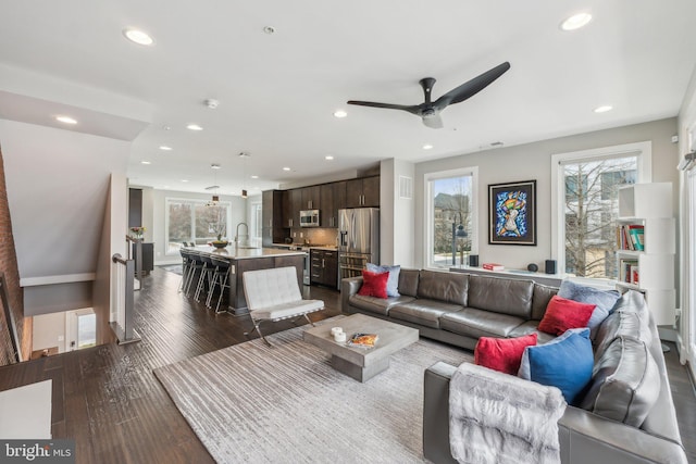 living area featuring dark wood finished floors, recessed lighting, and a wealth of natural light