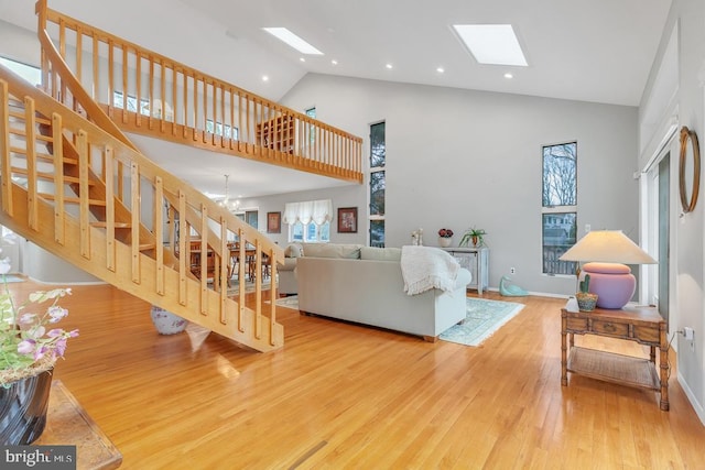 99 N Lakeshore, Manahawkin, NJ 08050 - living room with high vaulted ceiling, wood finished floors, a skylight, a chandelier, and stairs
