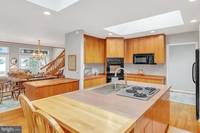 99 N Lakeshore, Manahawkin, NJ 08050 - kitchen featuring light wood-style flooring, black appliances, a skylight, and a chandelier