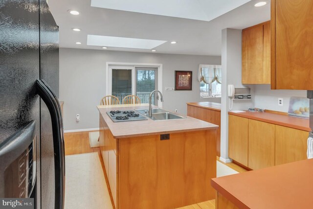 99 N Lakeshore, Manahawkin, NJ 08050 - kitchen with a center island with sink, freestanding refrigerator, a sink, light countertops, and stainless steel gas stovetop
