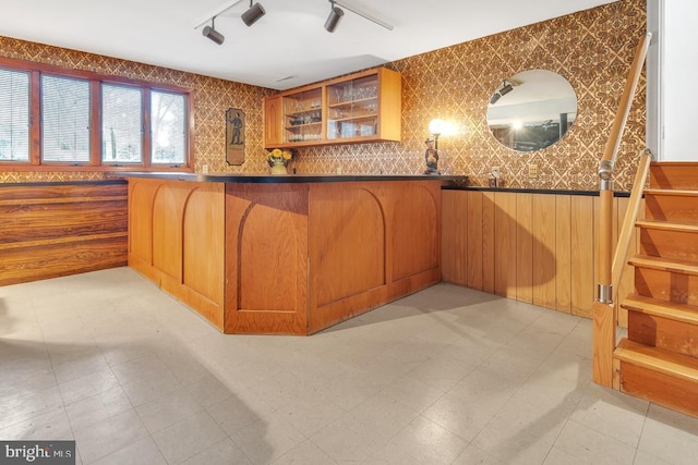99 N Lakeshore, Manahawkin, NJ 08050 - kitchen with a kitchen bar, dark countertops, brown cabinetry, glass insert cabinets, and light floors