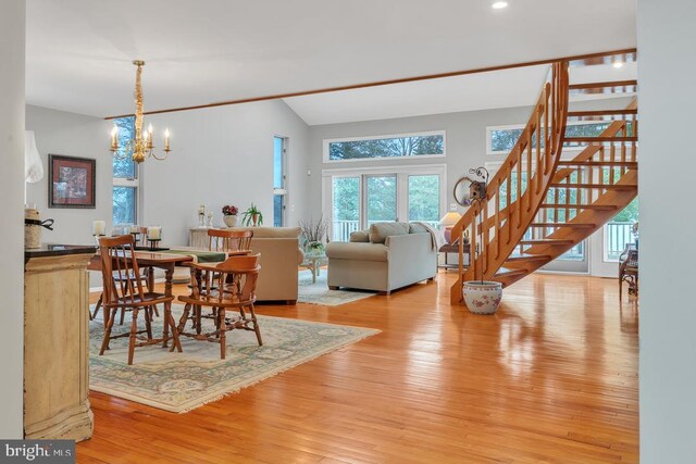 99 N Lakeshore, Manahawkin, NJ 08050 - dining room with lofted ceiling, a notable chandelier, hardwood / wood-style floors, and stairs