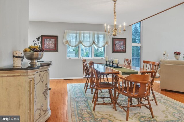 99 N Lakeshore, Manahawkin, NJ 08050 - dining area featuring light wood-type flooring, baseboards, and a notable chandelier