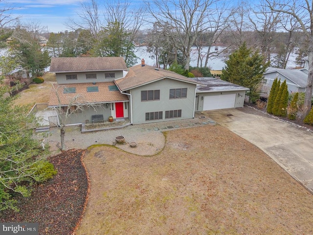 99 N Lakeshore, Manahawkin, NJ 08050 - view of front of house featuring concrete driveway, stucco siding, a garage, and a chimney