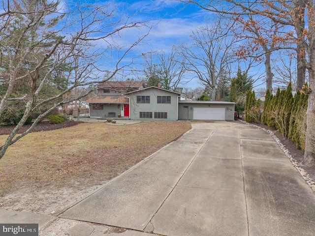 99 N Lakeshore, Manahawkin, NJ 08050 - view of front of home featuring concrete driveway, a garage, and a chimney