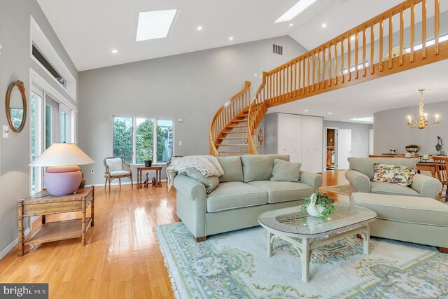 99 N Lakeshore, Manahawkin, NJ 08050 - living room featuring stairway, visible vents, high vaulted ceiling, a skylight, and a chandelier
