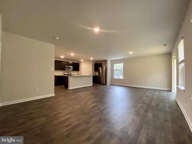 unfurnished living room featuring visible vents, recessed lighting, dark wood-style floors, and baseboards